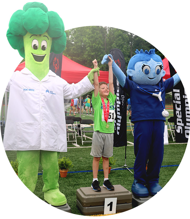 Image of Doc Broc and Nurse Blueberry celebrating with a young Special Olympics participant.