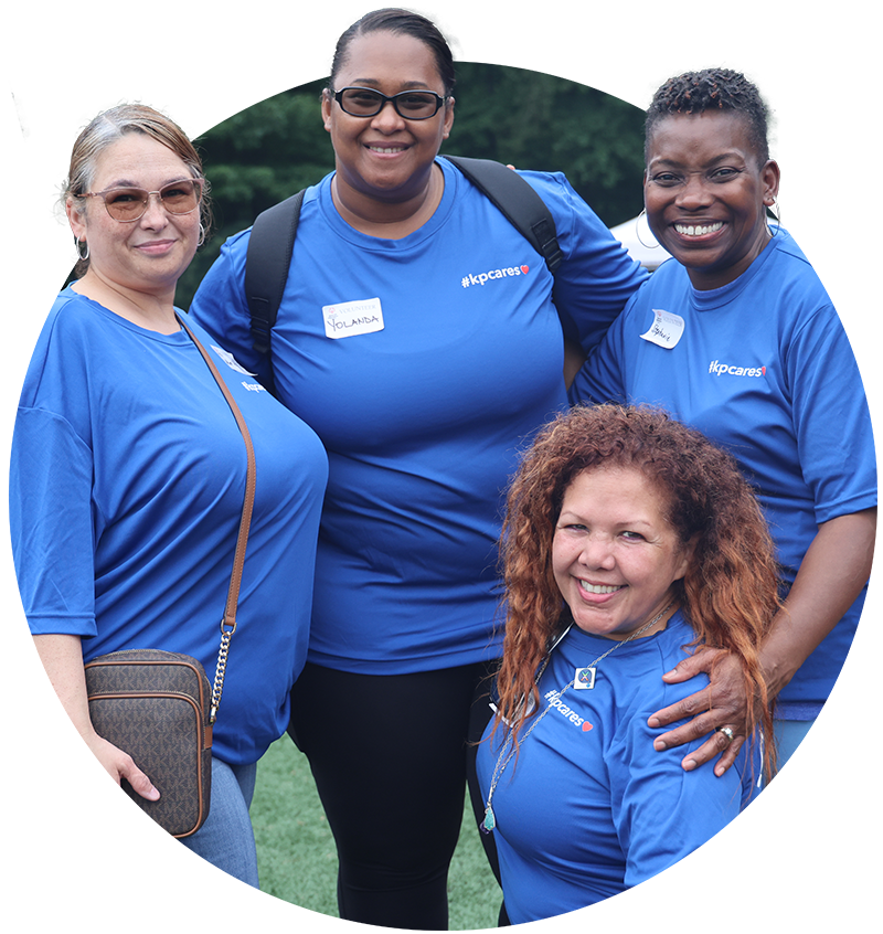 Four Kaiser Permanente volunteers in their KPCares shirts.