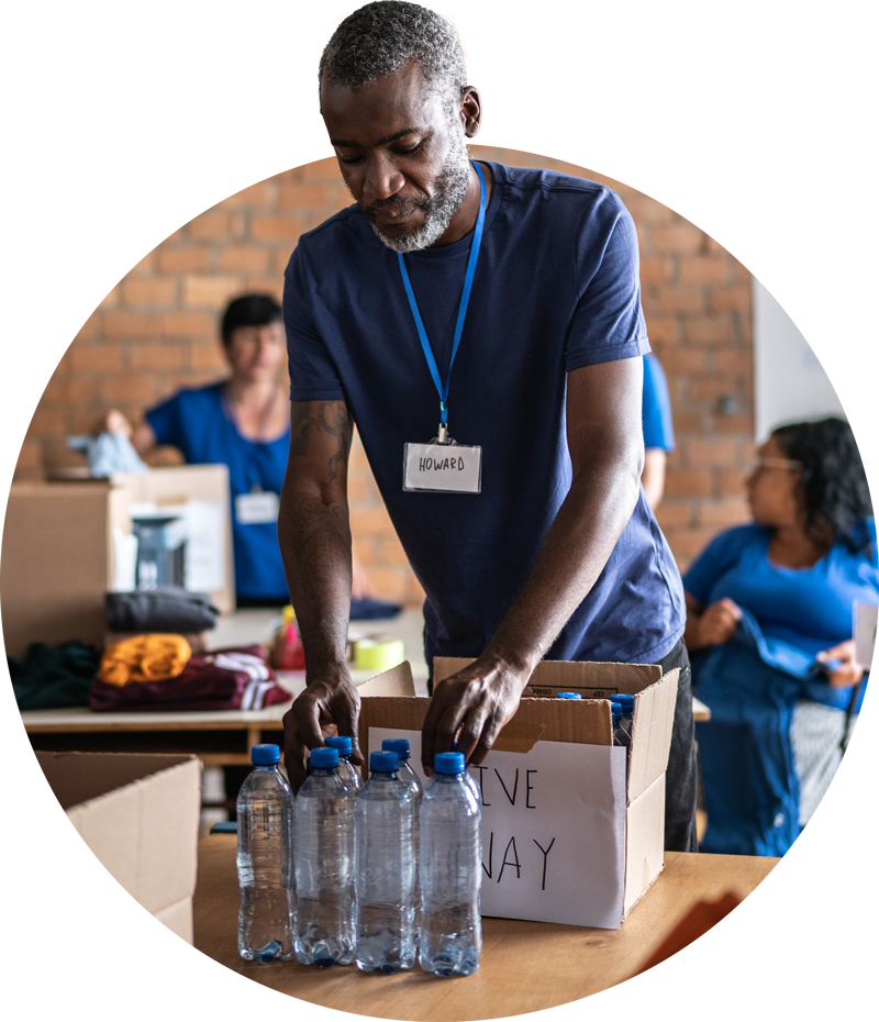 Photo of a volunteer packing water into boxes.