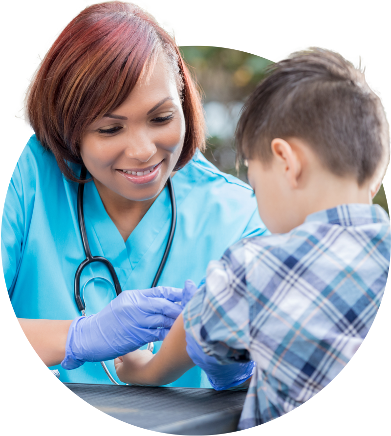 Photo of a volunteer nurse administering care to a child.